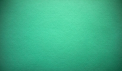 Photo of the texture of green felt fabric. Green background for felt text. The fabric is light...