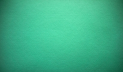 Photo of the texture of green felt fabric. Green background for felt text. The fabric is light green. Embroidery material.