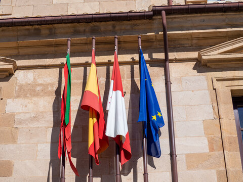 European and Spanish flags on the roof of a building in Europe - Powered by Adobe
