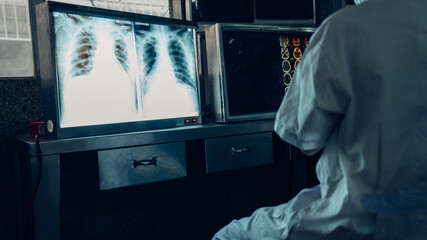 Medicine doctor working with a patients x-ray scans digital healthcare and connection.