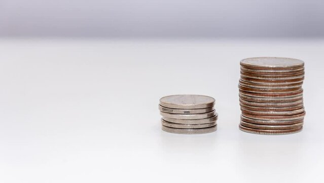 stop motion reduces the stack of coins on a white 