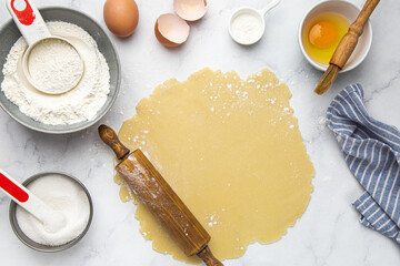 Making dough for pie or tart with rolling pin , baking and cooking concept