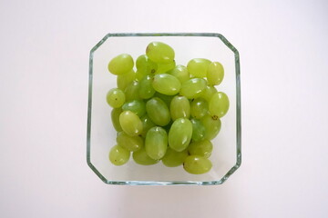 Green grapes in glass bowl isolated photo