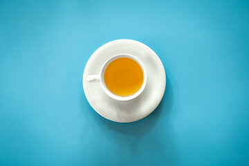 Cup of tea on blue background isolated, flat lay.
