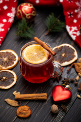 Fruity mulled wine on a wooden background with spices.