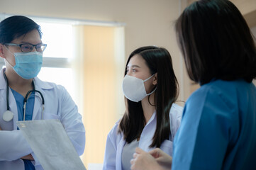 professional doctor and medicine person team have a conversation to talking in hospital about medical health care work, wearing surgical face mask