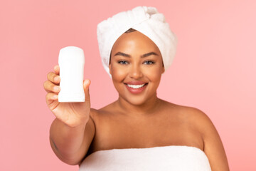 Happy Overweight Black Lady Showing Antiperspirant Stick Over Pink Background