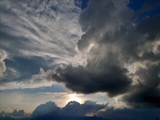 Bright deep blue sky with big white fluffy clouds. Glowing summer sky photo background.