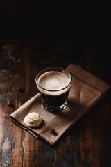 Coffee with milk on dark wooden background. Close up.