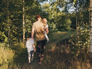A family walking and hiking in the forest. Father and son summer adventures. Vacation and...