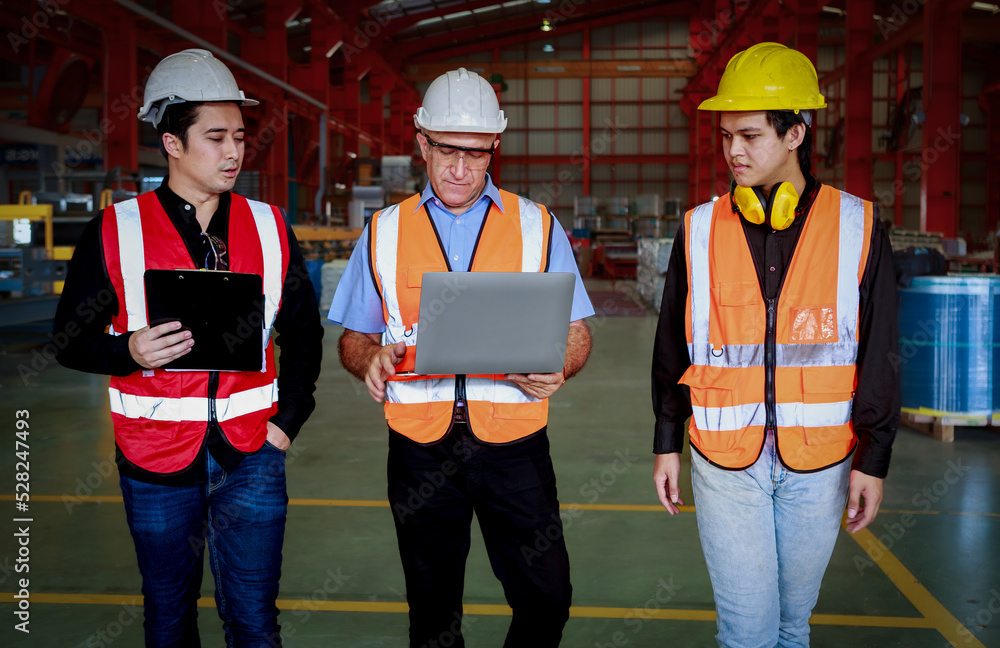 Aufkleber a manager using an empty laptop schematically with a team of multi-ethnic male engineers in safety c