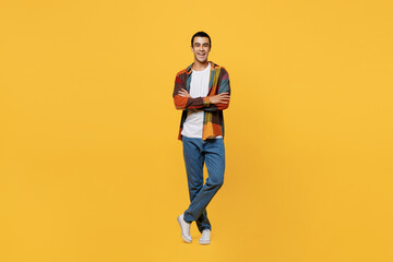 Fototapeta na wymiar Full body young smiling happy middle eastern man 20s wear casual shirt white t-shirt look camera hold hands crossed folded isolated on plain yellow background studio portrait People lifestyle concept.