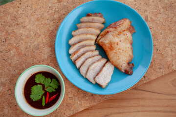 Roast pork and Thai Dipping Spicy Sauce on wooden table.Thailand street food.