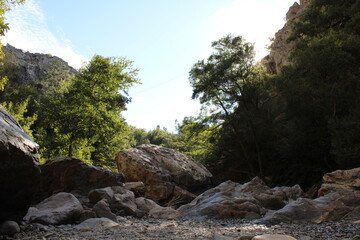 Fototapeta na wymiar Stream with transparent water. Large Rocks surrounded by running water. Fragas de São Simão, river beach, Figueiró dos Vinhos Portugal