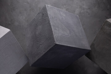 Cement block on floor background as construction concept. Concrete cube with abstract art idea
