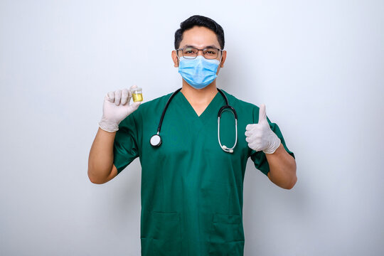 Doctor Or Clinic Lab Employee Holding Patient Urine Sample, Wear Medical Mask And Gloves, Thumb-up