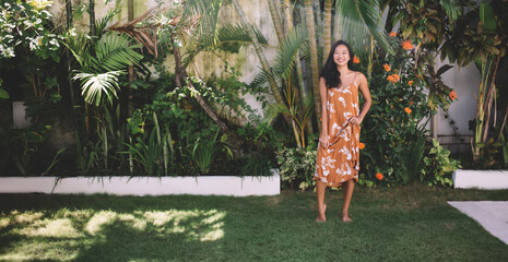 Beautiful asian girl posing in yard on Bali island - obrazy, fototapety, plakaty