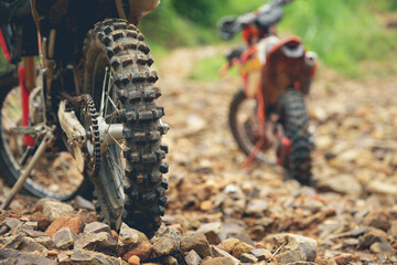 Part of a motocross wheel on a rocky road, with copy space for your individual text. A part of a...