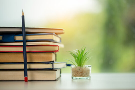 Object education green nature background with stack of ancient books or old bible, open paper book on wooden table with copy space. concept of back to school, research study
