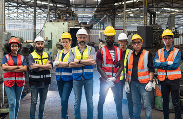 Team Workers and workers are standing in the factory. Group Staff Standing In Engineering Factory.