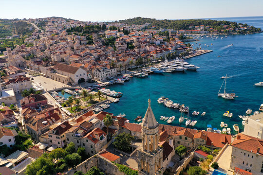 Croatian Island Hvar Harbor in Summertime with multiple moored Yachts and boats.