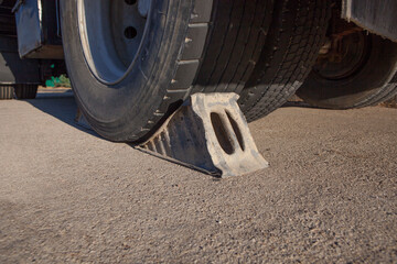 Metal wheel chock under trailer.