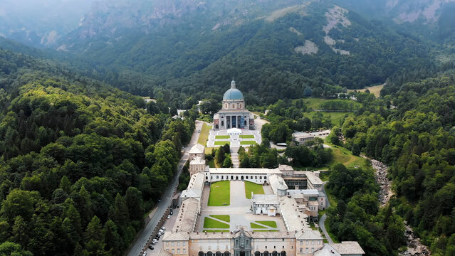 OROPA, BIELLA, ITALY - JULY 7, 2018: aero View of beautiful Shrine of Oropa, Facade with dome of the Oropa sanctuary located in mountains near the city of Biella, Piedmont, Italy. High quality photo