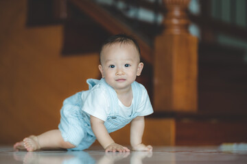 Cute little toddler trying and learning to crawl at home