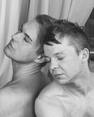 Gay couple. Two adult men are resting at home on the bed.