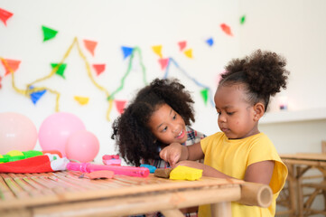 Two little girls Playing with plasticine