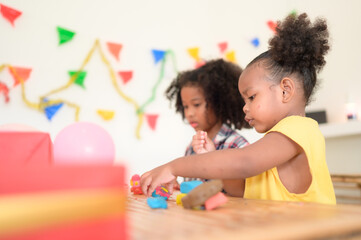 Two little girls Playing with plasticine