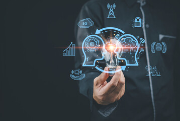 Businessman holding a light bulb for a smart industrial concept. AI technology, innovation and technology inspiration, innovation in science concepts and communicating the future world.