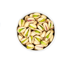 Pistachios in ceramic plate isolated on white background. Top view.