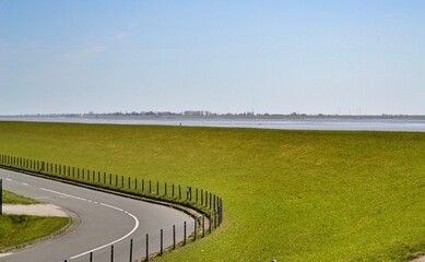 Obraz premium paved road against the sky and meadows