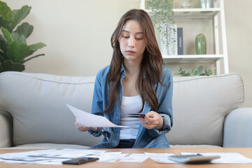 Financial household debt concept, stressed young asian woman trying to find money to pay credit card debt.