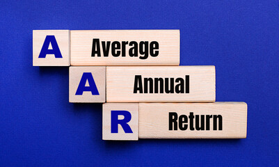 On a bright blue background, light wooden blocks and cubes with the text AAR Average Annual Return