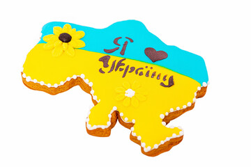 Gingerbread in the form of a map of Ukraine in yellow and blue colors with drawn hearts. Ukrainian.