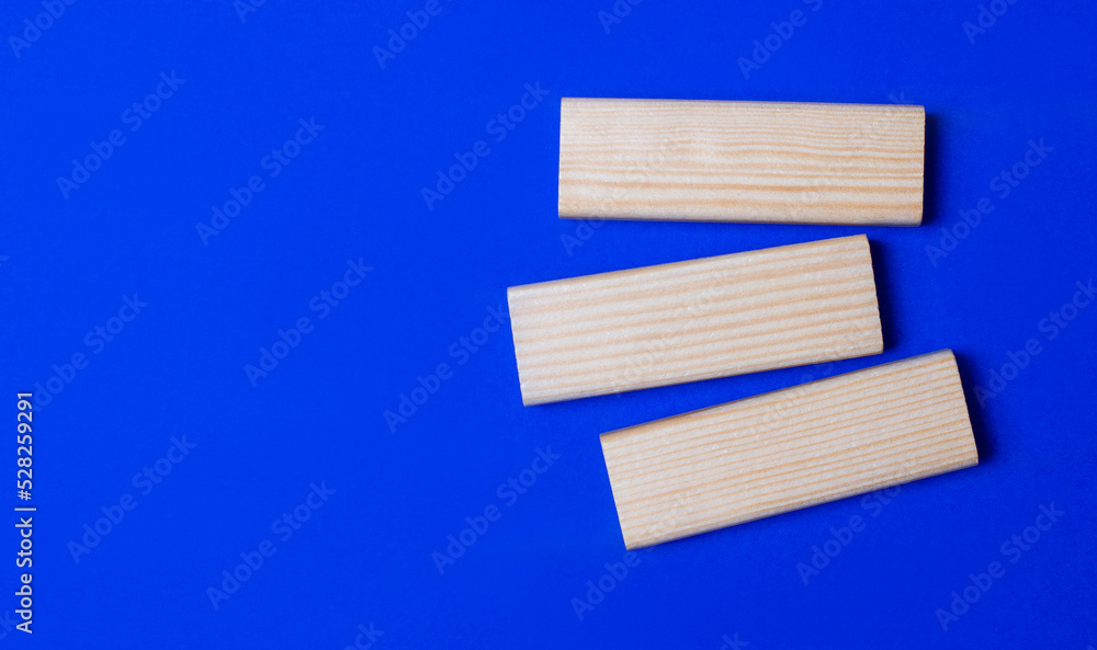 Poster three wooden blocks with space to insert text on a blue background. copy space