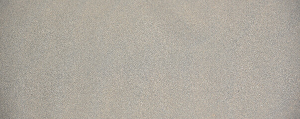 Gray textured background of river and sea sand as in the desert