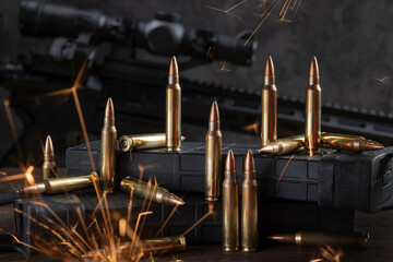 Cartridges and magazines for AR 15. Rifle in the background.