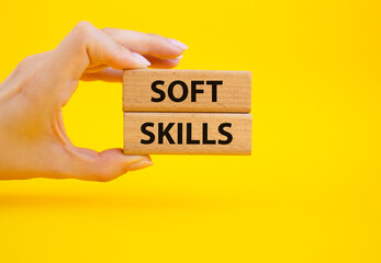 Soft skills symbol. Wooden blocks with words Soft skills. Beautiful yellow background. Businessman hand. Business and Soft skills concept. Copy space.