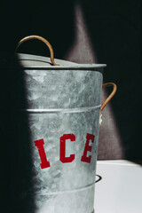 Metal ice bucket with partly illuminated red sign