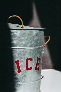 Metal ice bucket with partly illuminated red sign