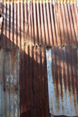 Rusted galvanized fence, used for a long time, resistant to sunlight and rain.