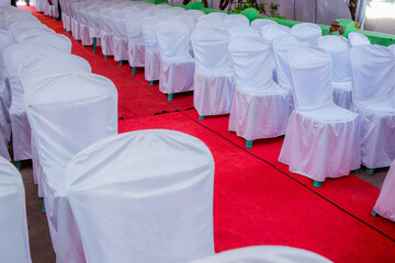 Chairs lined with white cloth covers