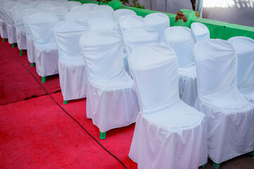 Chairs lined with white cloth covers