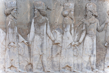 Bas-relief decoration along stairs from Darius palace to Palace of Xerxes. Ancient ruins of Persepolis near Shiraz in southern Iran. This UNESCO World Heritage Site showcases beautiful ruins from the 