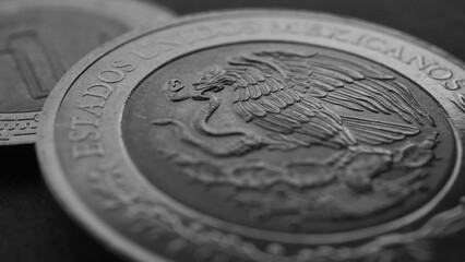 Coin of 5 Mexican pesos close-up. Peso of Mexico. Reverse of coin with coat of arms of country. Eagle and snake. Black and white money wallpaper. News about economy or business. Loan and credit. Macro