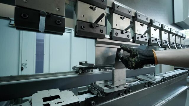 Operator working cut and bending metal sheet by high precision metal sheet bending machine, cnc control metal sheet bending machine in factory
