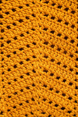 Yellow crochet texture with zigzag pattern.